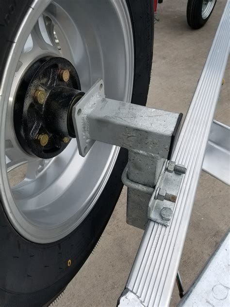 Magic tilt trailer tire bracket